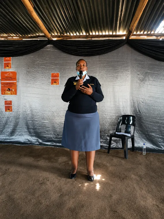 Portrait view of a speaker addressing a gender-based violence campaign